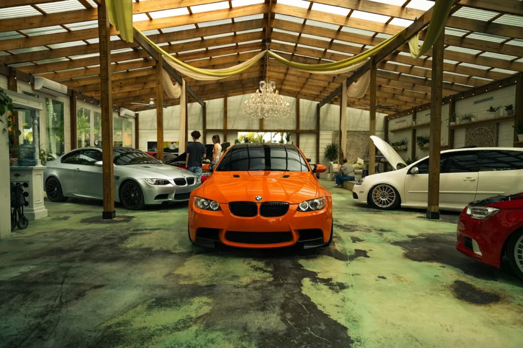 Orange BMW M3 in the greenhouse with chandelier